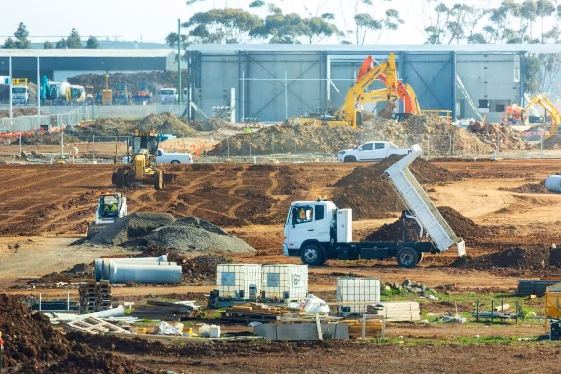 Construction site with trucks and construction equipment. Fixed Price building contract in construction