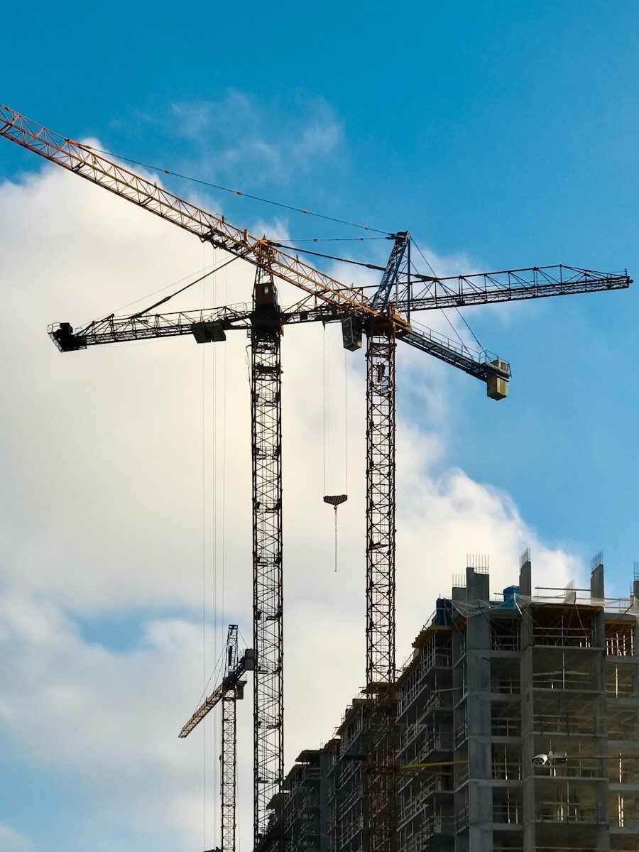 Industrial cranes on top of a construction building. Project Delivery Methods. Brisbane, Queensland, Australia