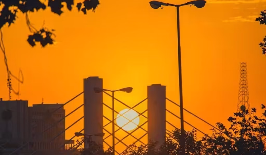 A bridge with a sunset in the background. Aerial view of high-rise buildings. Indemnities, Insurances and Limits of Liability in Construction Contracts. Large Business. AS2124-1992. AS2124. Business Growth Strategist. Business Growth Strategies.