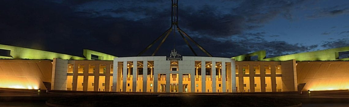 White concrete government building near body of water. Construction Law. Understanding conflicts of interest?