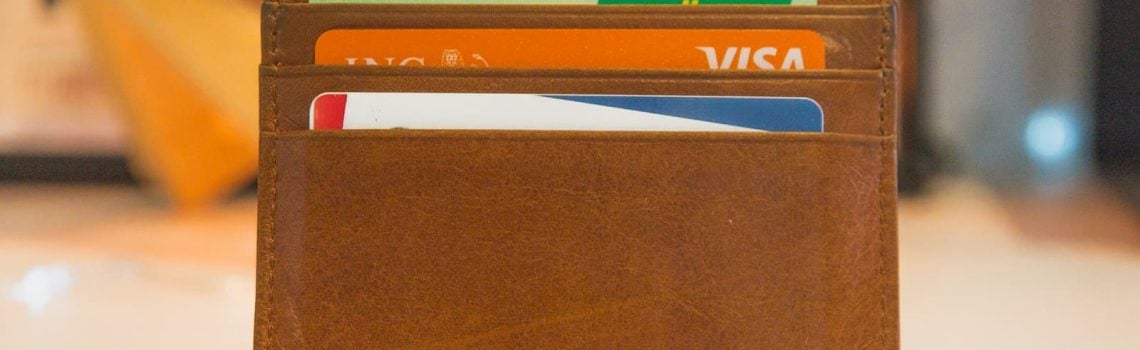 Brown wallet with bank cards. How to stop your business losing money on a construction project