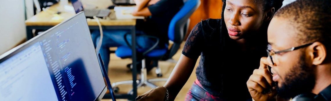 Woman and man sitting in front of monitor. Exploring Startup Funding Options. Blaze Business & Legal