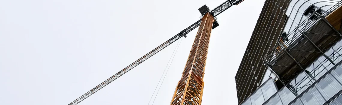 Crane above a building. Liquidated damages in construction contracts. Industries in Australia where we support our clients